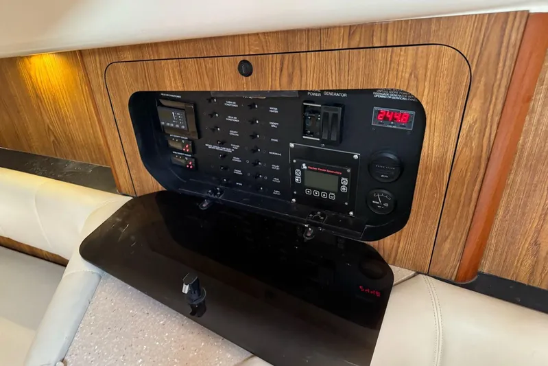  Yacht Photos Pics 2009 Pursuit OS 375 Offshore electrical panel with wood finish and digital display.