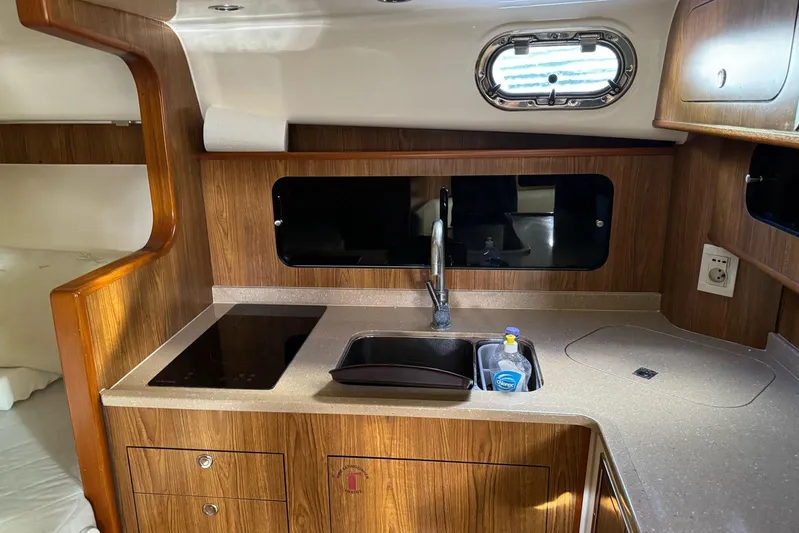  Yacht Photos Pics 2009 Pursuit OS 375 Offshore yacht kitchen with wood cabinetry and modern appliances.