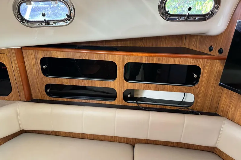  Yacht Photos Pics Interior of 2009 Pursuit OS 375 Offshore boat with wood cabinetry and beige seating.