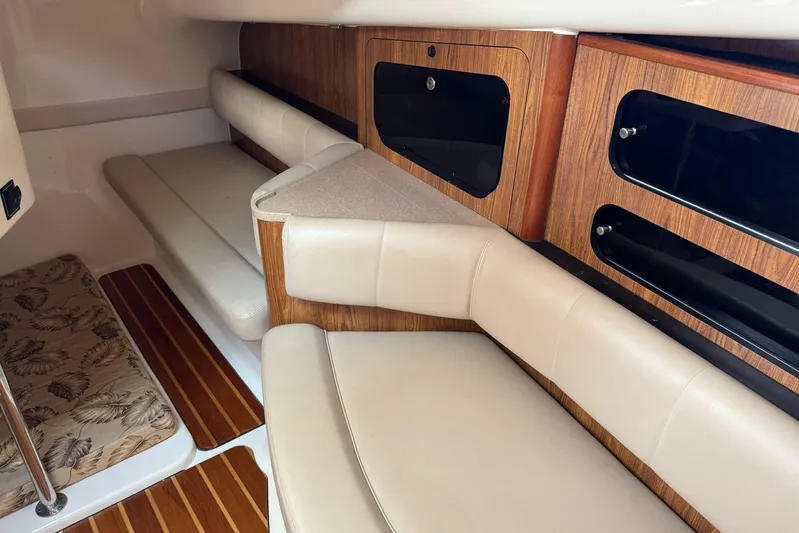  Yacht Photos Pics Interior of 2009 Pursuit OS 375 Offshore boat with beige seating and wooden accents.