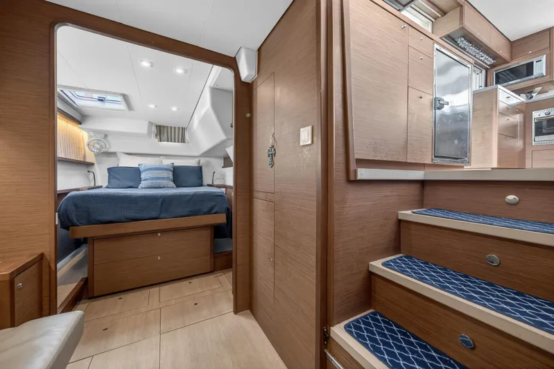  Yacht Photos Pics Luxurious interior of 2019 Lagoon 450 F catamaran with cozy bedroom and modern kitchen.