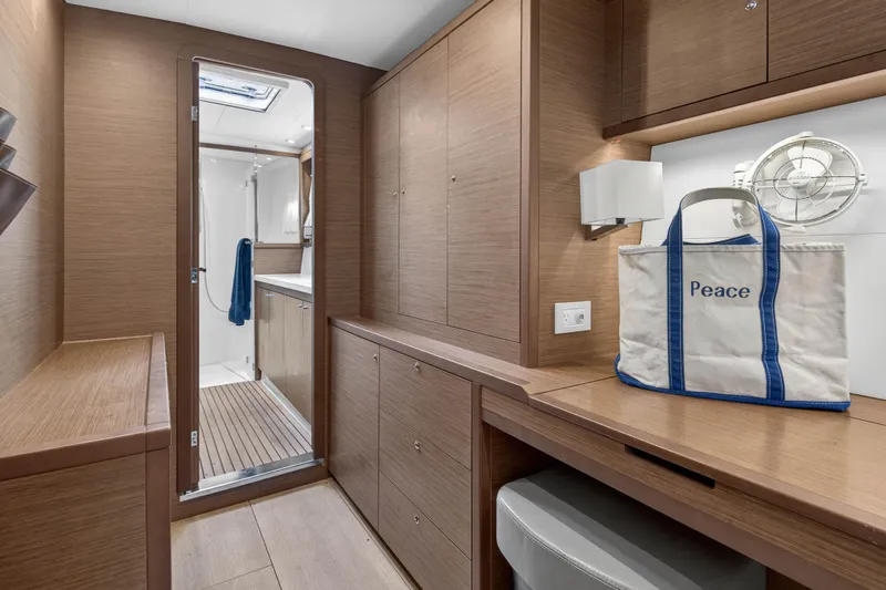  Yacht Photos Pics Interior of 2019 Lagoon 450 F yacht with wooden cabinetry and bathroom access.