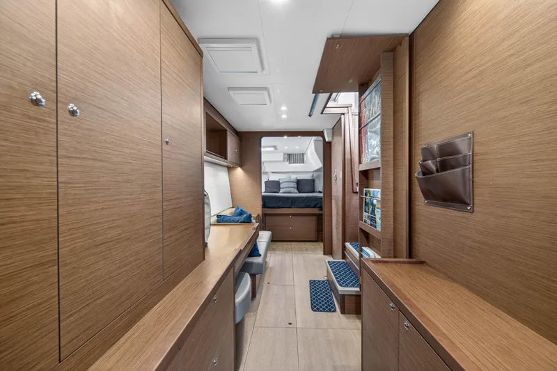 Yacht Photos Pics Interior of 2019 Lagoon 450 F yacht featuring modern wood finish and cozy sleeping area.