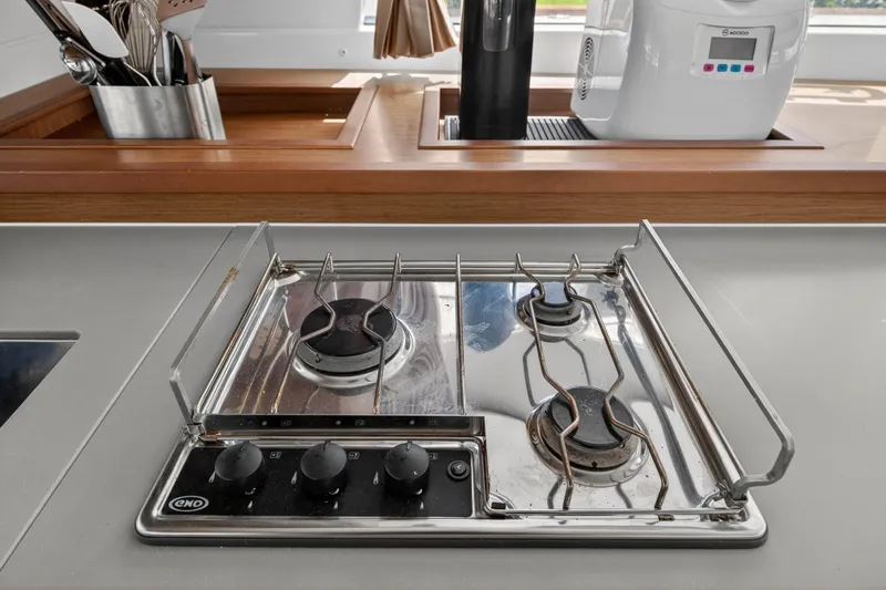  Yacht Photos Pics Modern kitchen stove on Lagoon 450 F yacht, 2019 model, with utensils and appliances.