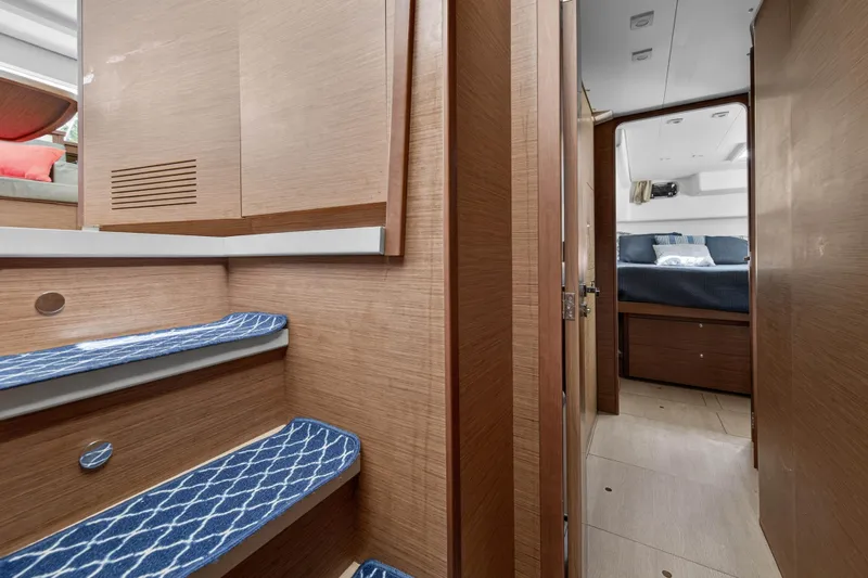  Yacht Photos Pics Interior of 2019 Lagoon 450 F yacht, featuring wooden stairs and cozy cabin.