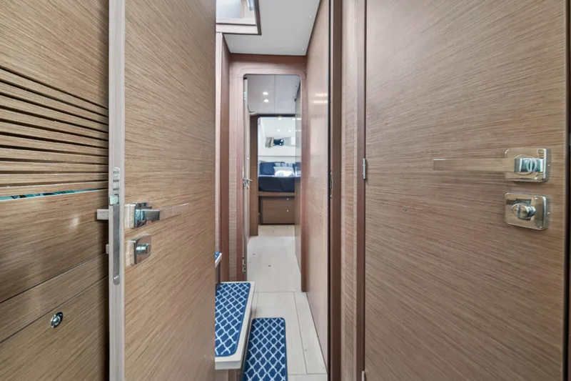  Yacht Photos Pics Interior hallway of 2019 Lagoon 450 F catamaran with wooden doors and modern design.