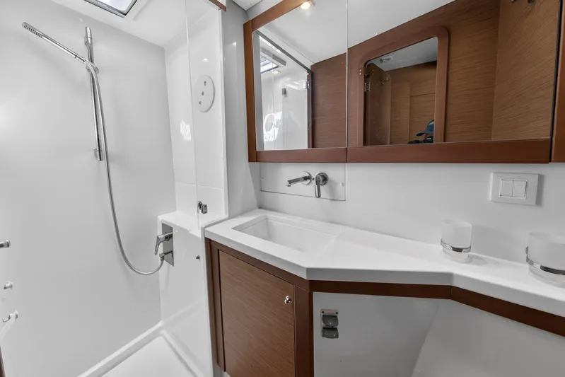  Yacht Photos Pics Modern bathroom in 2019 Lagoon 450 F yacht with sleek fixtures and wooden accents.