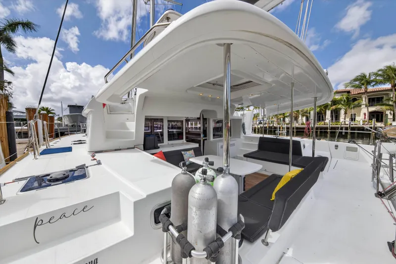  Yacht Photos Pics 2019 Lagoon 450 F catamaran with spacious deck, docked in a sunny marina.