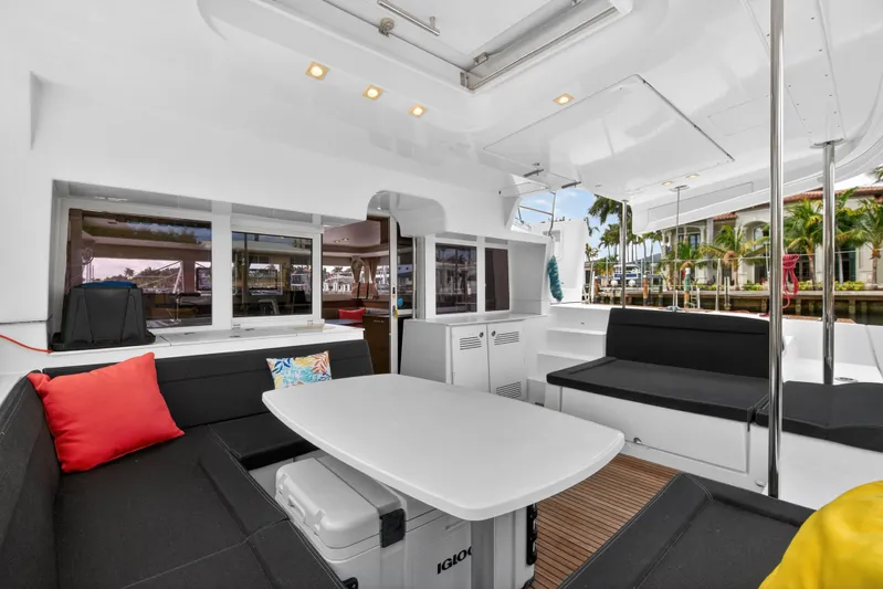  Yacht Photos Pics Spacious 2019 Lagoon 450 F yacht interior with seating, table, and tropical view.