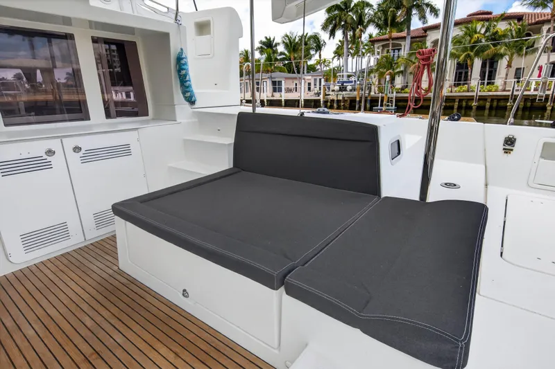  Yacht Photos Pics 2019 Lagoon 450 F yacht deck with cushioned seating and wooden flooring.