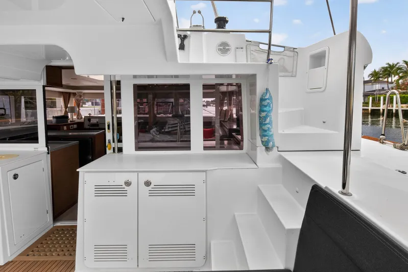  Yacht Photos Pics 2019 Lagoon 450 F yacht interior with modern kitchen and outdoor seating area.