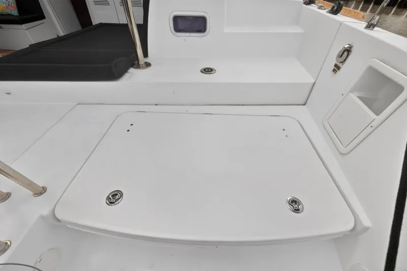  Yacht Photos Pics 2019 Lagoon 450 F yacht deck with storage compartment and seating area.