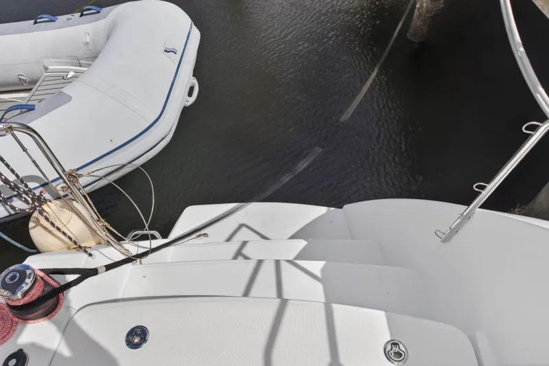 Yacht Photos Pics 2019 Lagoon 450 F yacht deck with inflatable boat on water.