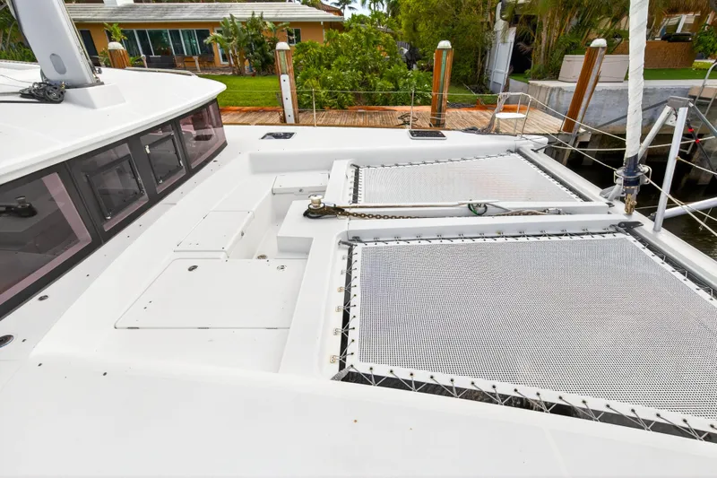  Yacht Photos Pics 2019 Lagoon 450 F catamaran deck with netting and dockside view.