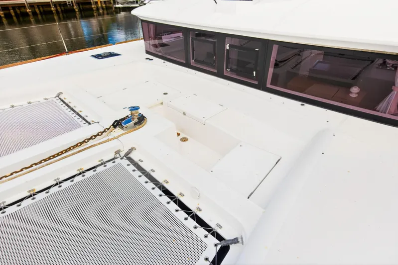  Yacht Photos Pics 2019 Lagoon 450 F catamaran deck with winch and netting, dockside view.