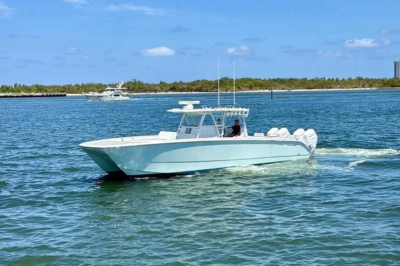  Yacht Photos Pics 2020 Invincible 40 Catamaran cruising on a sunny day in open waters.