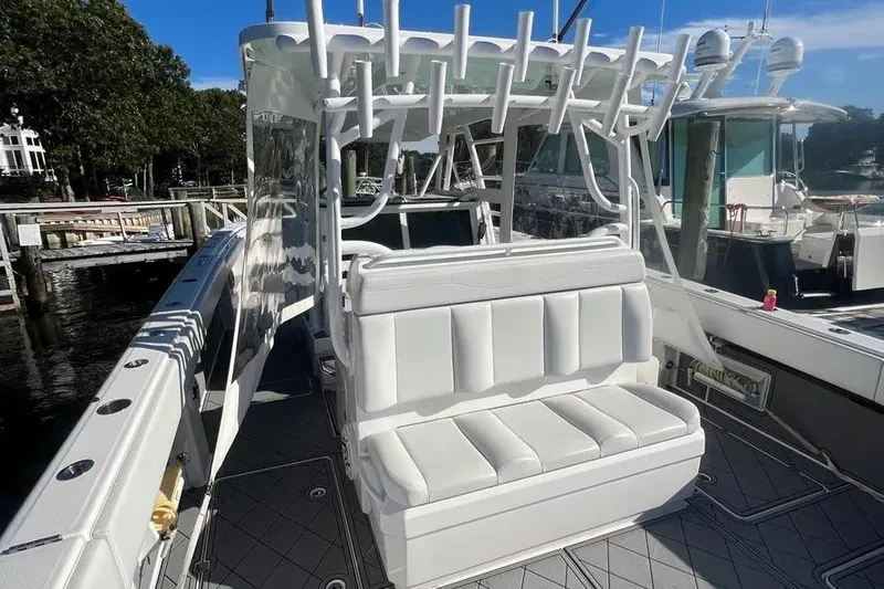  Yacht Photos Pics 2020 Invincible 40 Catamaran with white seating and rod holders at a marina.