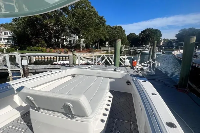  Yacht Photos Pics Invincible 40 Catamaran 2020 docked at a scenic marina with lush greenery.