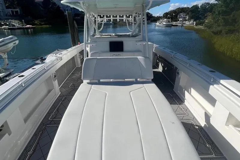  Yacht Photos Pics 2020 Invincible 40 Catamaran with spacious deck and seating, docked in serene waters.