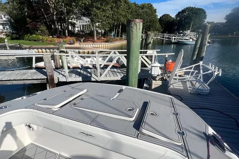  Yacht Photos Pics 2020 Invincible 40 Catamaran docked at a scenic marina with lush greenery.