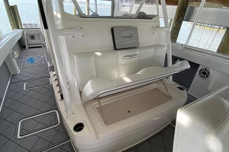  Yacht Photos Pics 2020 Invincible 40 Catamaran interior with seating and Garmin equipment, docked by the water.