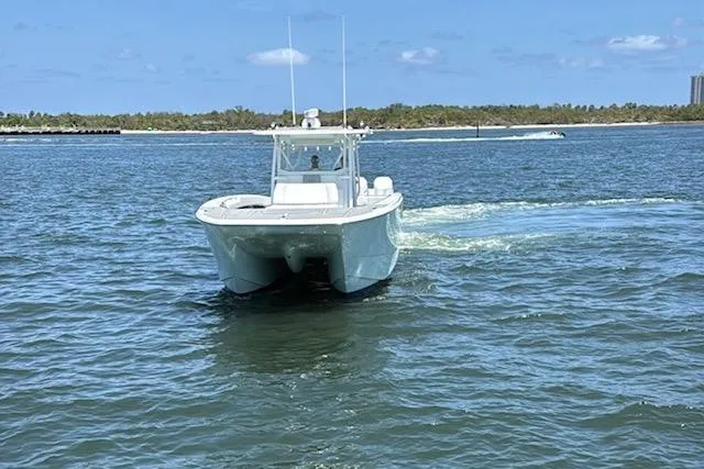  Yacht Photos Pics 2020 Invincible 40 Catamaran cruising on open water under a clear blue sky.