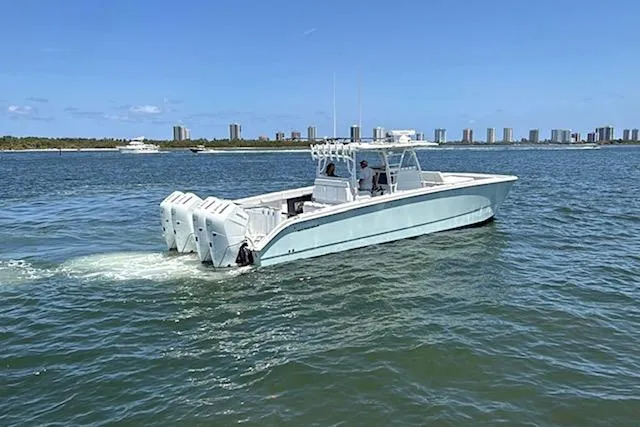  Yacht Photos Pics 2020 Invincible 40 Catamaran cruising on a sunny day near a city skyline.