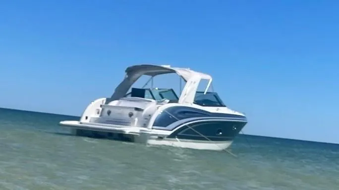  Yacht Photos Pics 2021 Formula 350 Crossover Bowrider in shallow water, clear blue sky.