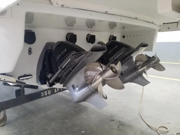  Yacht Photos Pics 2021 Formula 350 Crossover Bowrider dual propellers and outdrives in a garage.