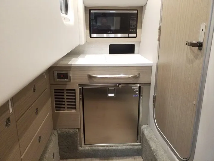  Yacht Photos Pics 2021 Formula 350 Crossover Bowrider cabin kitchen with microwave and mini-fridge.