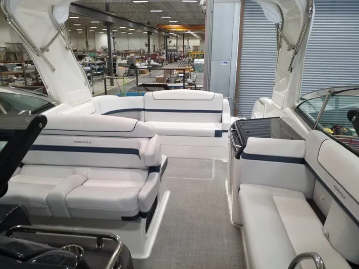  Yacht Photos Pics 2021 Formula 350 Crossover Bowrider interior with white and blue seating in a showroom.