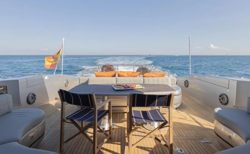 Drift Yacht Photos Pics Luxury 2005 Mangusta 92 yacht deck with seating, table, and ocean view.