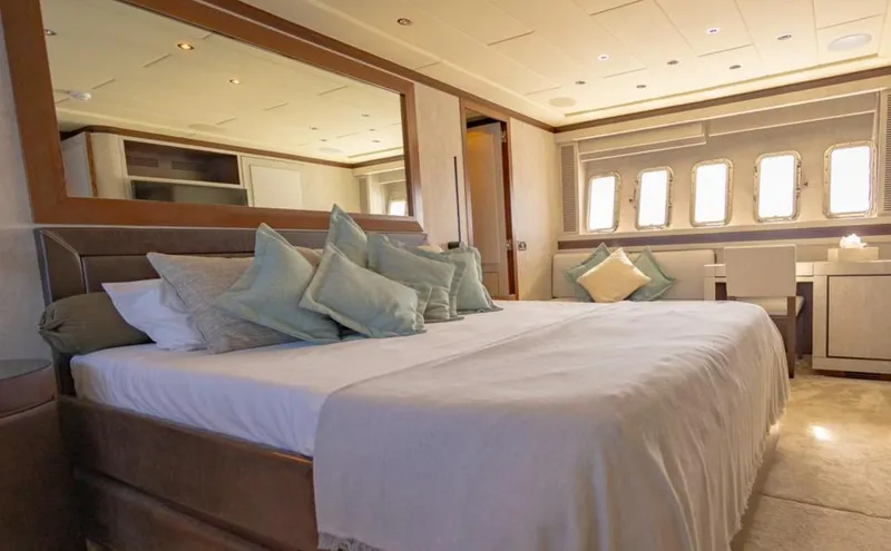 Drift Yacht Photos Pics Luxurious bedroom interior of 2005 Mangusta Mangusta 92 yacht with elegant bedding and decor.