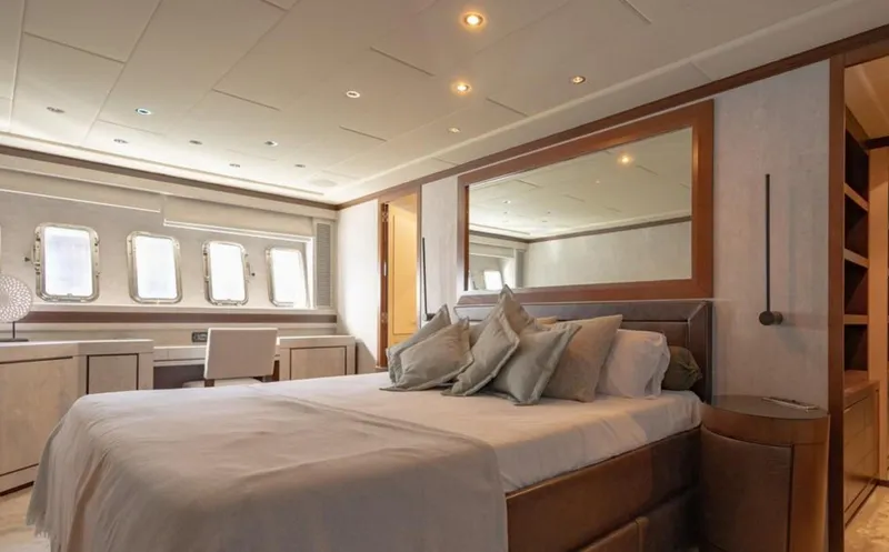 Drift Yacht Photos Pics Luxurious bedroom interior of 2005 Mangusta 92 yacht with elegant decor and ample natural light.