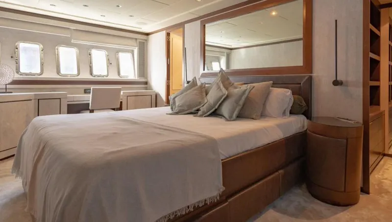 Drift Yacht Photos Pics Luxurious bedroom interior of 2005 Mangusta 92 yacht with elegant decor and large bed.