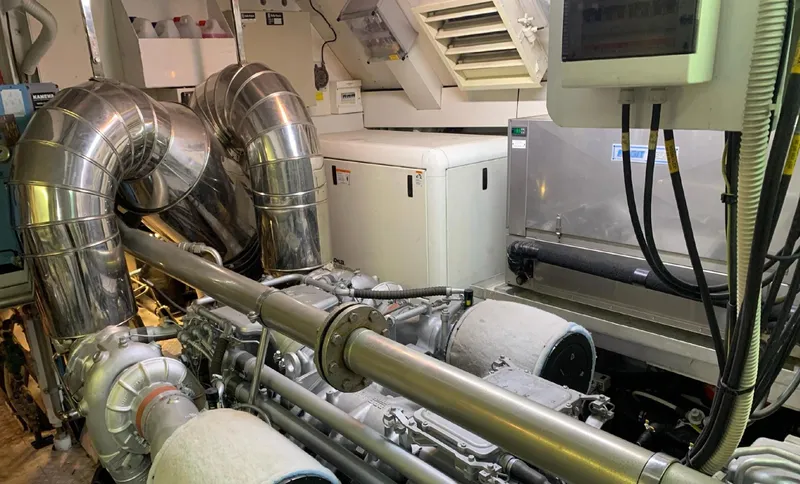 Drift Yacht Photos Pics Engine room of 2005 Mangusta 92 yacht with metallic pipes and machinery.