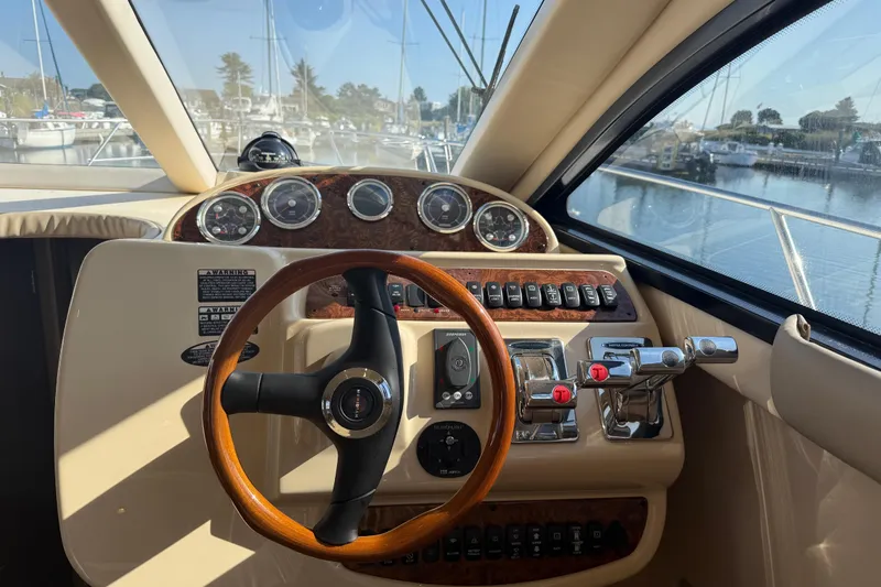 Her Idea Yacht Photos Pics 2005 Meridian 381 yacht helm with wooden steering wheel and control panel.