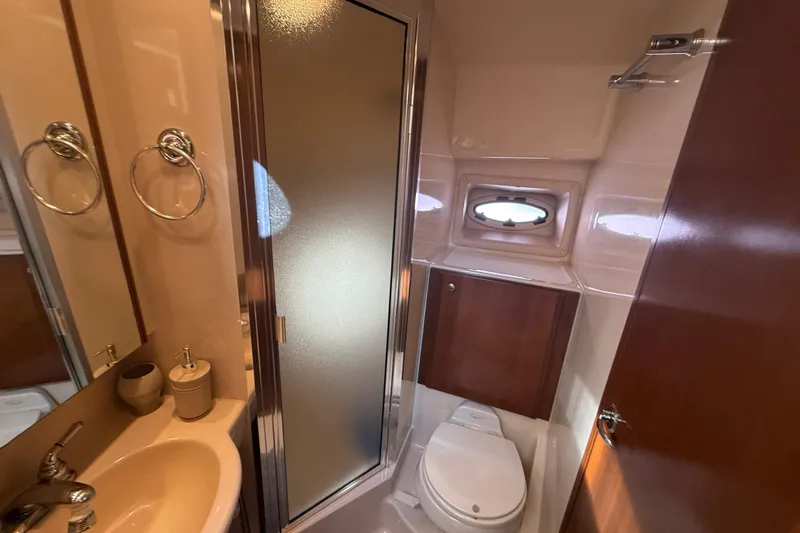 Her Idea Yacht Photos Pics 2005 Meridian 381 yacht bathroom with shower, sink, and porthole window.