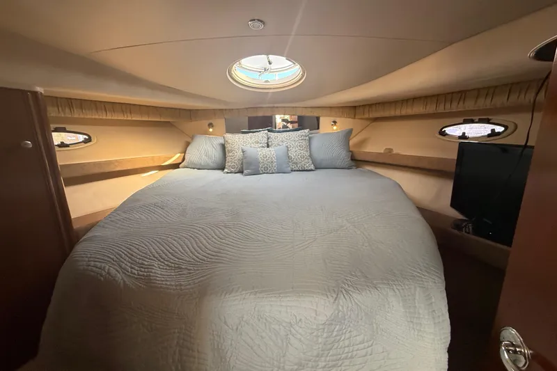 Her Idea Yacht Photos Pics Luxurious bedroom interior of 2005 Meridian 381 yacht with cozy bedding and porthole windows.