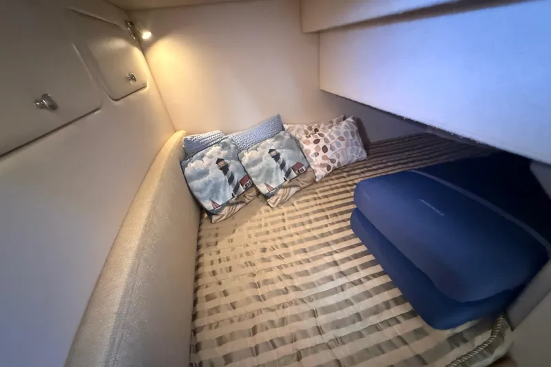 Her Idea Yacht Photos Pics Cozy cabin interior of 2005 Meridian 381 yacht with decorative pillows and soft lighting.