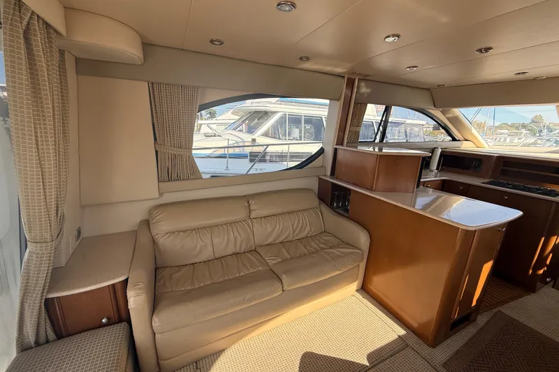 Her Idea Yacht Photos Pics Luxurious 2005 Meridian 381 yacht interior with leather seating and elegant wood finishes.