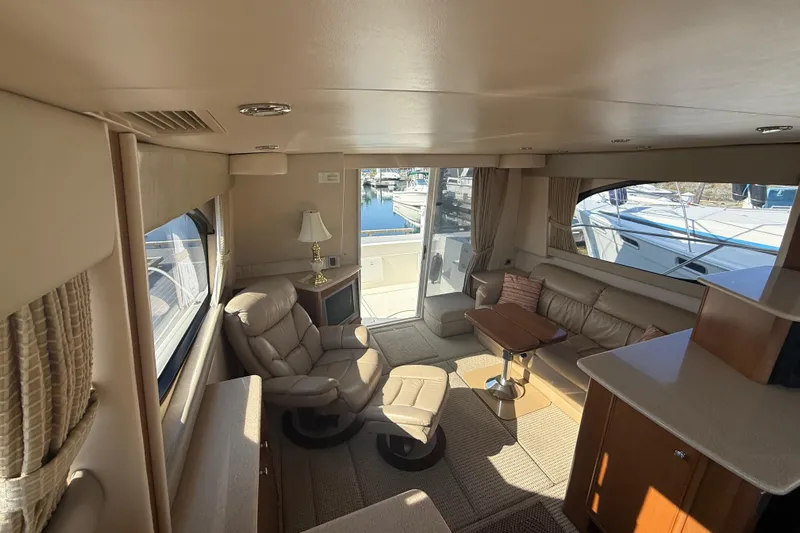 Her Idea Yacht Photos Pics Luxurious interior of 2005 Meridian 381 yacht with leather seating and marina view.