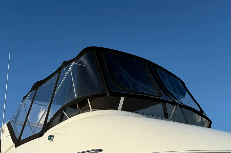 Her Idea Yacht Photos Pics 2005 Meridian 381 boat with clear enclosure against blue sky.