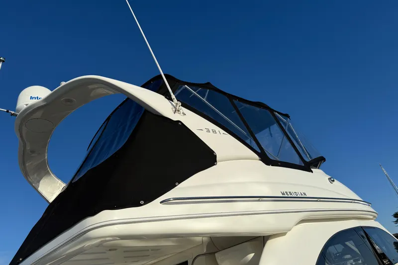 Her Idea Yacht Photos Pics 2005 Meridian 381 yacht with black canopy against clear blue sky.