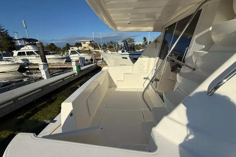 Her Idea Yacht Photos Pics 2005 Meridian 381 yacht docked at marina, featuring spacious deck and sleek design.