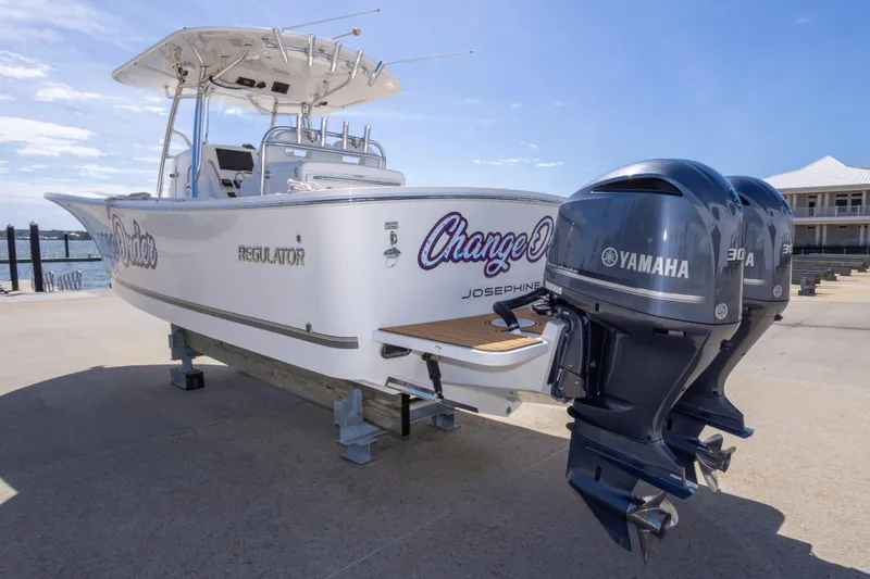 Change Order Yacht Photos Pics 2018 Regulator 31 boat with twin Yamaha 300 engines docked by the water.