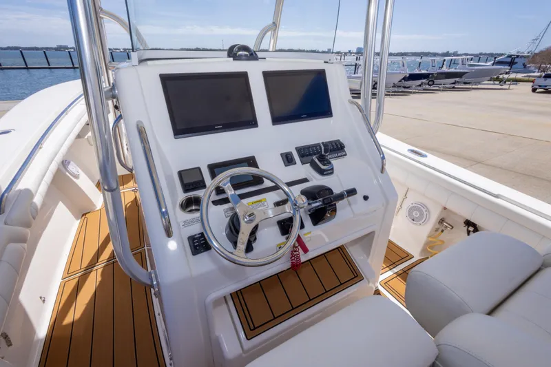 Change Order Yacht Photos Pics 2018 Regulator 31 boat helm with dual screens and modern controls, dockside view.