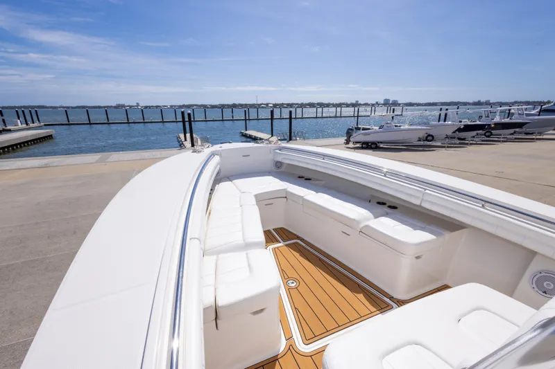Change Order Yacht Photos Pics 2018 Regulator 31 boat with spacious seating, docked by a scenic waterfront.