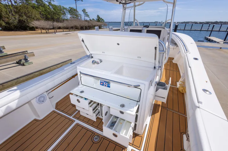 Change Order Yacht Photos Pics 2018 Regulator 31 boat interior with open storage compartments and teak flooring.