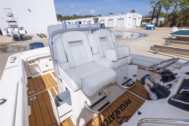 Change Order Yacht Photos Pics 2018 Regulator 31 boat interior with white seating and teak flooring at a marina.
